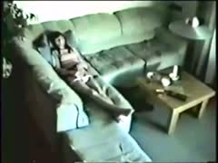 Unaware of a concealed camera, the adorable wife masturbates on a couch.